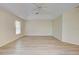 Spacious bedroom featuring light neutral walls and wood-look flooring at 339 Meadow Beauty Ct, Venice, FL 34293