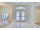 Bright entryway with double doors and tiled flooring at 339 Meadow Beauty Ct, Venice, FL 34293