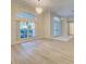 Spacious entryway with arched windows and wood-look floors at 339 Meadow Beauty Ct, Venice, FL 34293