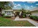 Single story home with a welcoming entryway and tropical landscaping at 339 Meadow Beauty Ct, Venice, FL 34293
