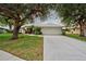 Single-story house with a two-car garage and lush landscaping at 339 Meadow Beauty Ct, Venice, FL 34293