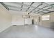 Garage with high ceiling and overhead storage at 339 Meadow Beauty Ct, Venice, FL 34293