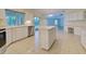 Kitchen with island, stainless steel appliances, and ample counter space at 339 Meadow Beauty Ct, Venice, FL 34293