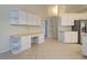 Kitchen with white cabinets and built-in desk area at 339 Meadow Beauty Ct, Venice, FL 34293