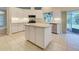 Bright kitchen with island, stainless steel appliances, and white cabinets at 339 Meadow Beauty Ct, Venice, FL 34293