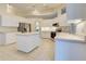 Spacious kitchen with island, stainless steel appliances and white cabinets at 339 Meadow Beauty Ct, Venice, FL 34293