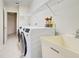 Bright laundry room with washer, dryer and utility sink at 339 Meadow Beauty Ct, Venice, FL 34293
