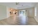 Living room with sliding glass doors to backyard and kitchen views at 339 Meadow Beauty Ct, Venice, FL 34293