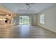 Living room with sliding glass doors, hardwood floors, and views of the backyard at 339 Meadow Beauty Ct, Venice, FL 34293