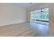 Living room featuring wood-look floors and access to a screened patio at 339 Meadow Beauty Ct, Venice, FL 34293