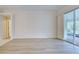 Spacious living area with wood-look floors and access to a patio at 339 Meadow Beauty Ct, Venice, FL 34293