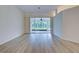 Bright living room with sliding glass doors leading to a screened patio at 339 Meadow Beauty Ct, Venice, FL 34293