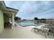 Community pool with lounge chairs and patio area at 339 Meadow Beauty Ct, Venice, FL 34293