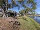 Peaceful backyard oasis with pond view, lush grass, and mature trees at 341 Pembroke Ln # 227, Venice, FL 34293
