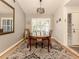 Bright dining room features wood floors and charming table setting at 341 Pembroke Ln # 227, Venice, FL 34293