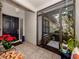Inviting front porch with potted plants and a screen door at 341 Pembroke Ln # 227, Venice, FL 34293