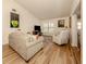 Relaxing living room with hardwood floors, comfortable seating, and large windows at 341 Pembroke Ln # 227, Venice, FL 34293