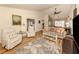 Spacious living room with hardwood floors, comfortable seating and lots of natural light at 341 Pembroke Ln # 227, Venice, FL 34293