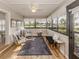 Bright sunroom features hardwood floors, comfy seating and views of the outdoors at 341 Pembroke Ln # 227, Venice, FL 34293