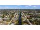 An aerial view shows a long narrow canal cutting through a neighborhood of single Gathering homes at 3560 Middletown St, Port Charlotte, FL 33952