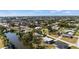 Expansive aerial view of the neighborhood and distant ocean, nestled within lush trees and green landscape at 3560 Middletown St, Port Charlotte, FL 33952