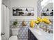 Bathroom features modern fixtures, geometric wallpaper, and beach-themed wall decor at 3560 Middletown St, Port Charlotte, FL 33952