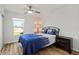 Bedroom featuring a ceiling fan, wood-look floor, double bed and dark furniture at 3560 Middletown St, Port Charlotte, FL 33952