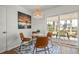 Dining area features a modern light fixture and a sliding door to the back patio at 3560 Middletown St, Port Charlotte, FL 33952