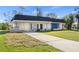 Charming single-story home featuring a well-manicured lawn, front yard, and a lengthy private driveway at 3560 Middletown St, Port Charlotte, FL 33952