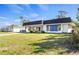 Charming single-story home featuring a well-manicured lawn, front yard, and a lengthy private driveway at 3560 Middletown St, Port Charlotte, FL 33952