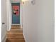 Hallway features wood floors, neutral paint, and a modern toucan print on an accent wall at 3560 Middletown St, Port Charlotte, FL 33952
