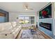 Bright living room with large window, modern electric fireplace and view to the front yard at 3560 Middletown St, Port Charlotte, FL 33952