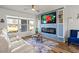 Bright living room with large window, modern electric fireplace and view to the front yard at 3560 Middletown St, Port Charlotte, FL 33952
