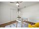 Office featuring glass desk, ceiling fan, wood-look floor and rug at 3560 Middletown St, Port Charlotte, FL 33952