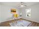 Bright office features a glass desk, ceiling fan, wood-look floor and rug at 3560 Middletown St, Port Charlotte, FL 33952