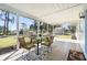 Comfortable screened porch with an outdoor dining area and views of the landscaped yard at 3560 Middletown St, Port Charlotte, FL 33952
