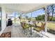 Inviting screened porch with stylish outdoor furniture and views of the backyard at 3560 Middletown St, Port Charlotte, FL 33952
