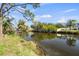 Beautiful waterfront view surrounded by tropical vegetation, reflecting a serene and tranquil setting at 3560 Middletown St, Port Charlotte, FL 33952