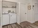 Laundry room with washer, dryer, and shelving at 4060 Barbary Ln, North Port, FL 34287