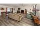 Open living room with hardwood floors, a view to the pool area, and comfortable furniture at 4060 Barbary Ln, North Port, FL 34287