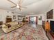 Living room with hardwood floors, a ceiling fan, and access to a patio at 4060 Barbary Ln, North Port, FL 34287