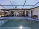 Screened pool and patio with seating and a beautiful view at 4060 Barbary Ln, North Port, FL 34287