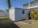 White storage shed in backyard with small window at 4060 Barbary Ln, North Port, FL 34287