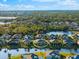 Aerial view of single-Gathering home with a screened lanai, situated on a tranquil lake at 4264 Wordsworth Way, Venice, FL 34293