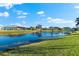 Tranquil backyard view showcasing a serene lake and lush greenery at 4264 Wordsworth Way, Venice, FL 34293