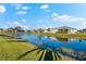 Picturesque backyard with a tranquil lake view and lush grass at 4264 Wordsworth Way, Venice, FL 34293