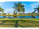 Serene backyard oasis featuring a tranquil lake view and lush landscaping at 4264 Wordsworth Way, Venice, FL 34293