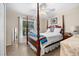Bedroom with a wooden four-poster bed and window at 4264 Wordsworth Way, Venice, FL 34293