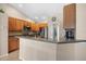 Modern kitchen with stainless steel appliances and wood cabinets at 4264 Wordsworth Way, Venice, FL 34293