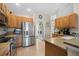 Modern kitchen with stainless steel appliances and wood cabinets at 4264 Wordsworth Way, Venice, FL 34293